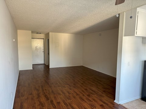 A room with wooden floors and white walls.